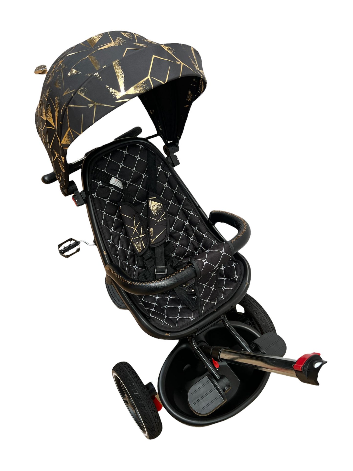 Triciclo plegable, asiento reversible, color negro y dorado.